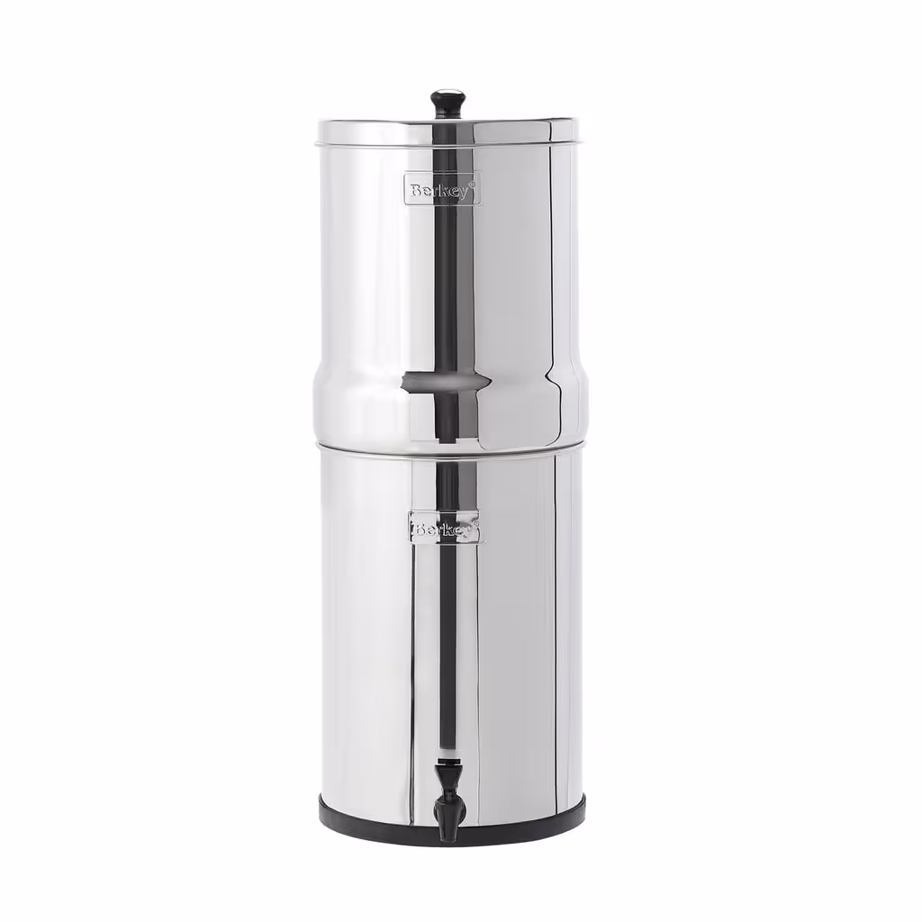 Crown Berkey gravity water filter: a tall high-capacity stainless-steel two-chamber countertop system with a front spigot, standing on a white background