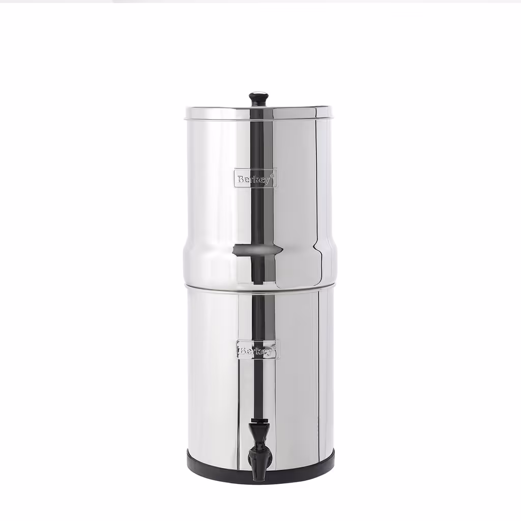 Travel Berkey gravity water filter: a compact stainless-steel two-chamber countertop system with a front spigot, standing on a white background